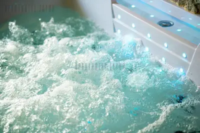 a pool of water in a tub with a splash at Aparthotel ZATOR Cactus 57 jacuzzi in Zator