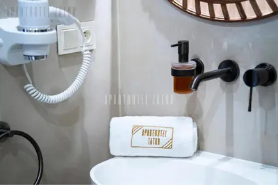 a bathroom with a toilet with a phone and a towel at Aparthotel ZATOR Cactus 57 jacuzzi in Zator