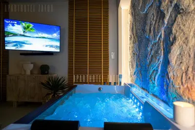 a large tub in a room with a tv at Aparthotel ZATOR Cactus 57 jacuzzi in Zator