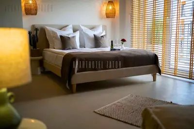 a bedroom with a large bed with white pillows at Aparthotel ZATOR Cactus 57 jacuzzi in Zator