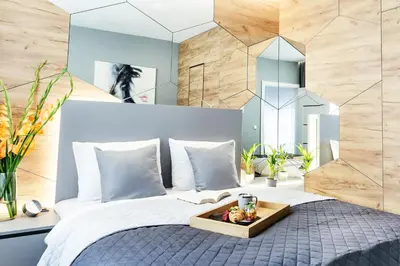 a bedroom with a bed with a tray of fruit on it at Golden Queen Apartments Old Town in Kraków