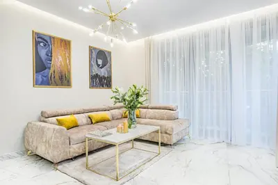 a living room with a couch and a table at Golden Queen Apartments Old Town in Kraków