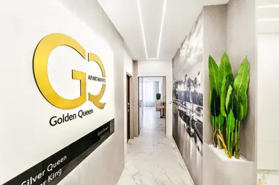 a hallway with a c logo on the wall at Golden Queen Apartments Old Town in Kraków