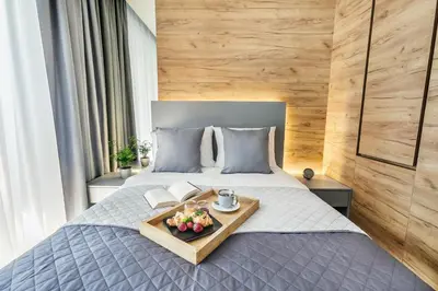 a tray of fruit on a bed in a bedroom at Golden Queen Apartments Old Town in Kraków
