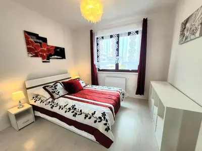 a white bedroom with a bed and a window at Apartment Sophie 3 rooms, 2 bathrooms, 8 persons in Kraków