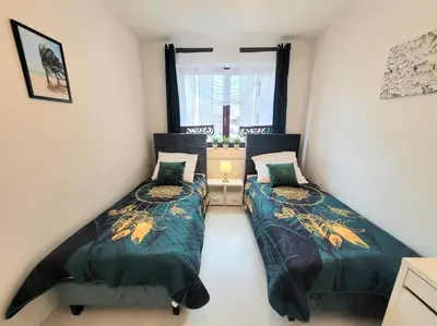 a bedroom with two beds and a window at Apartment Sophie 3 rooms, 2 bathrooms, 8 persons in Kraków