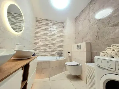 a bathroom with a sink and a washing machine at Apartment Sophie 3 rooms, 2 bathrooms, 8 persons in Kraków