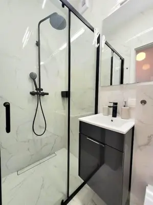 a bathroom with a shower and a sink at Apartment Sophie 3 rooms, 2 bathrooms, 8 persons in Kraków