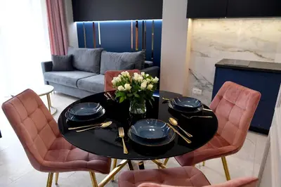 a living room with a table with a vase of flowers at CoCo Elite Apartments Zator in Zator