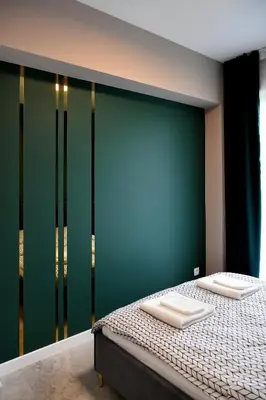 a living room with a flat screen tv hanging on a wall at CoCo Elite Apartments Zator in Zator