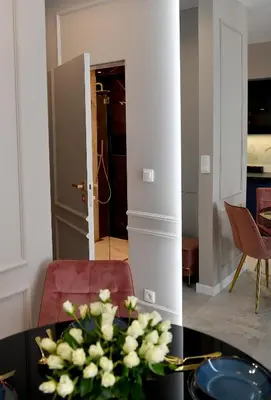 a kitchen and dining room with a table and pink chairs at CoCo Elite Apartments Zator in Zator