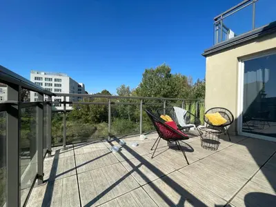 a deck with three chairs and chairs on a balcony at Tyzenhauz Apartments Arianska Street in Kraków