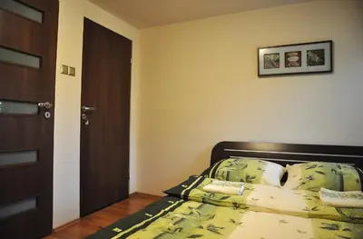 a bedroom with a bed and a door in it at Najlepsze Miejsce - pokoje i apartamenty w Krakowie in Kraków