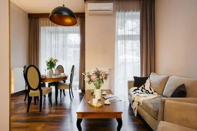 a living room with a couch and a table at Topolowa Residence by StayLab in Kraków