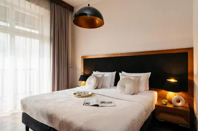 a bedroom with a large bed with a tray on it at Topolowa Residence by StayLab in Kraków