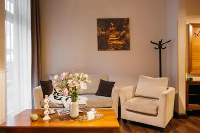 a living room with a table and two chairs at Topolowa Residence by StayLab in Kraków
