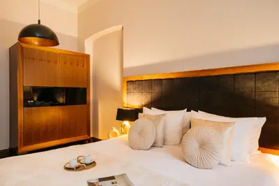 a bedroom with a large white bed with white pillows at Topolowa Residence by StayLab in Kraków