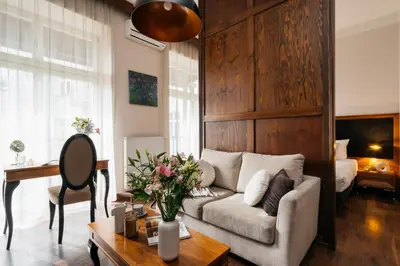 a living room with a couch and a table at Topolowa Residence by StayLab in Kraków