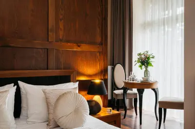 a hotel room with a bed and a table with a tableasonable at Topolowa Residence by StayLab in Kraków