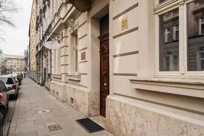 a narrow street with a door on a building at Topolowa Residence by StayLab in Kraków