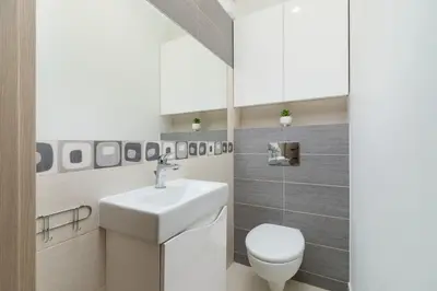 a bathroom with a white sink and a toilet at Cystersów Apartment Cracow by Noclegi Renters in Kraków