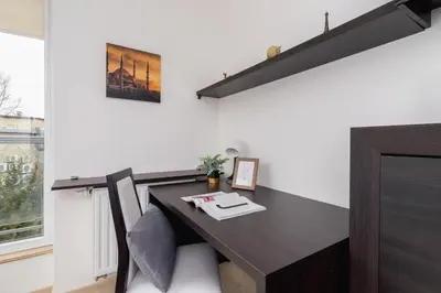 a dining table in a room with a window at Cystersów Apartment Cracow by Noclegi Renters in Kraków