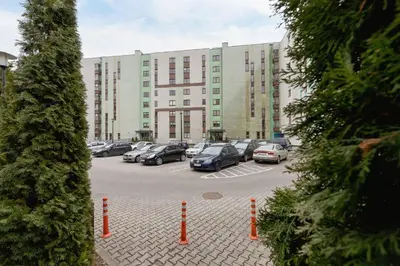 a parking lot with cars parked in front of a building at Cystersów Apartment Cracow by Noclegi Renters in Kraków