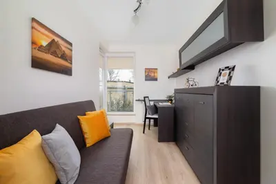 a living room with a couch and a table at Cystersów Apartment Cracow by Noclegi Renters in Kraków