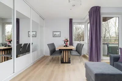 a living room with a table and chairs at Cystersów Apartment Cracow by Noclegi Renters in Kraków