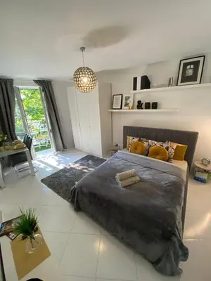 a bedroom with a large bed and a chandelier at Podskale Apartment in Kraków