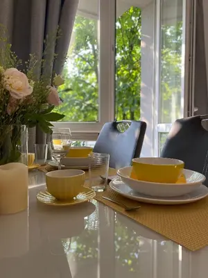 a dining room table with yellow dishes on it at Podskale Apartment in Kraków