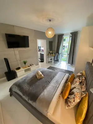a large bed in a living room with a couch at Podskale Apartment in Kraków