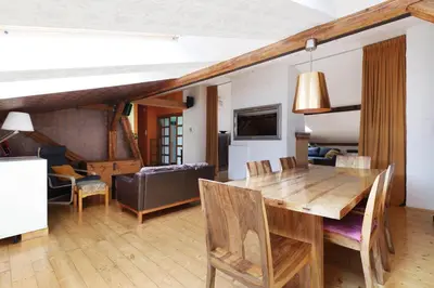a living room with a wooden table and chairs at Karmelicka 34 by Homeprime in Kraków