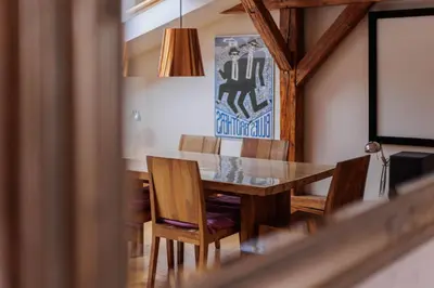 a dining room with a wooden table and chairs at Karmelicka 34 by Homeprime in Kraków