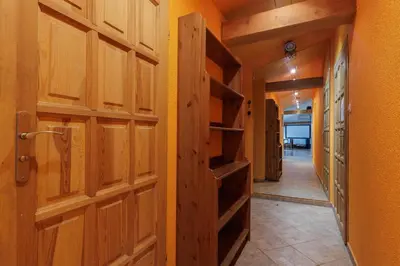a hallway with wooden doors and shelves in a house at Karmelicka 34 by Homeprime in Kraków