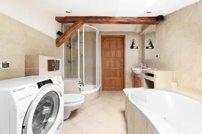 a bathroom with a washing machine and a toilet at Karmelicka 34 by Homeprime in Kraków