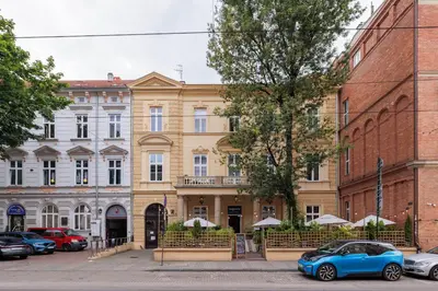 a blue car parked in front of a building at Karmelicka 34 by Homeprime in Kraków
