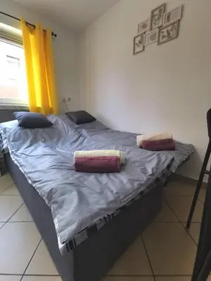 a bed with two pillows on it in a room at Wyspani Zator in Zator