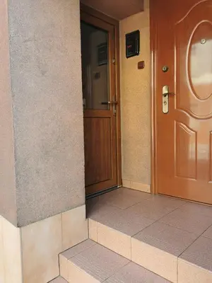 an entrance to a building with a wooden door at Wyspani Zator in Zator
