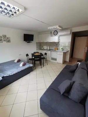 a living room with a couch and a table at Wyspani Zator in Zator