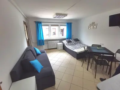 a living room with a couch and a table at Wyspani Zator in Zator