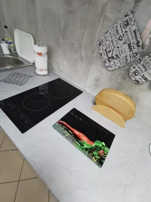 a kitchen counter with a stove and a cutting board at Wyspani Zator in Zator