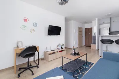 a living room with a desk and two chairs in it at Family Apartment with Parking & Terrace by Noclegi Renters in Kraków
