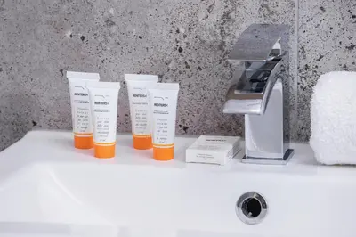 three tubes of sunscreen sitting on top of a bathroom sink at Family Apartment with Parking & Terrace by Noclegi Renters in Kraków