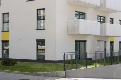a white building with white balconies on it at Family Apartment with Parking & Terrace by Noclegi Renters in Kraków