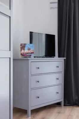 a dresser with a tv on top of it at Elegant Pet-Friendly Studio in Krakow by Noclegi Renters in Kraków
