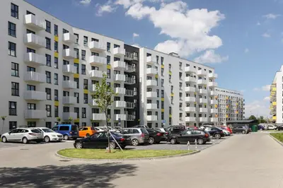 a parking lot with cars parked in front of a building at Elegant Pet-Friendly Studio in Krakow by Noclegi Renters in Kraków