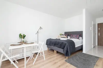 a bedroom with a bed and a table and chairs at Elegant Pet-Friendly Studio in Krakow by Noclegi Renters in Kraków