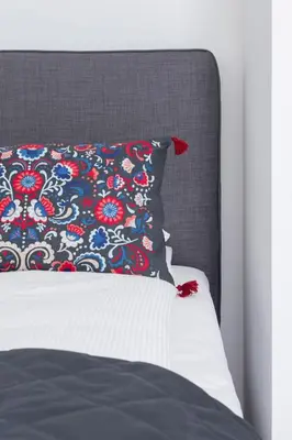 a bed with a black and red pillow on it at Elegant Pet-Friendly Studio in Krakow by Noclegi Renters in Kraków