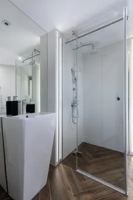 a bathroom with a shower with a glass door at Vistula Boulevards Jacuzzi Apartment in Kraków